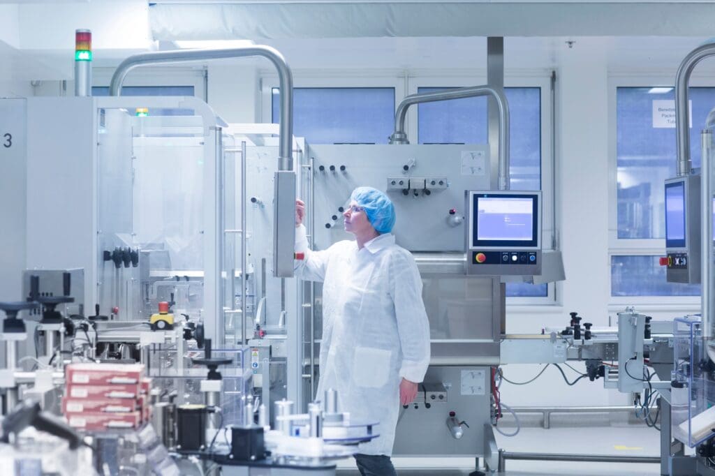 Worker operating machinery in pharmaceutical plant