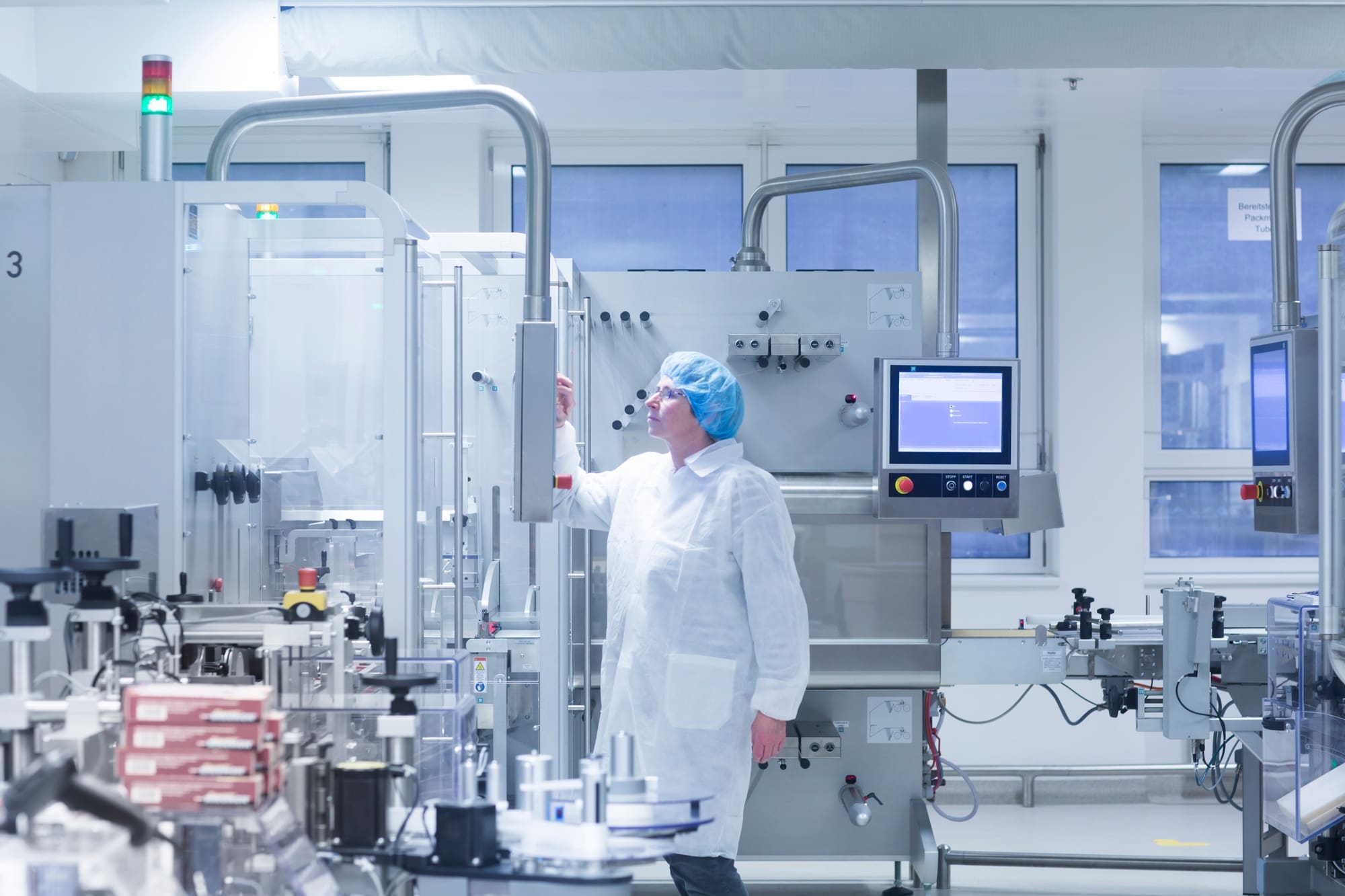 Worker operating machinery in pharmaceutical plant